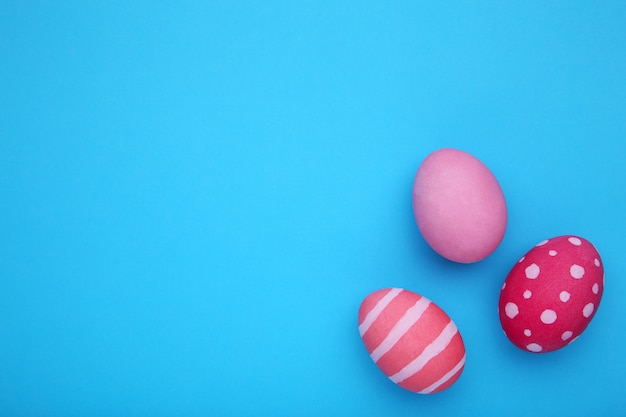 Three easter eggs on a blue 