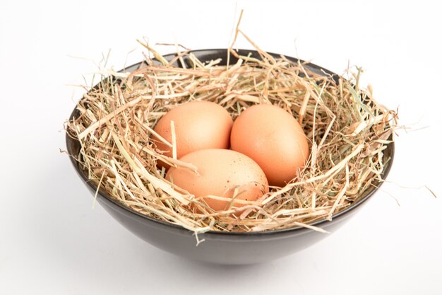 Three eggs in a black bowl