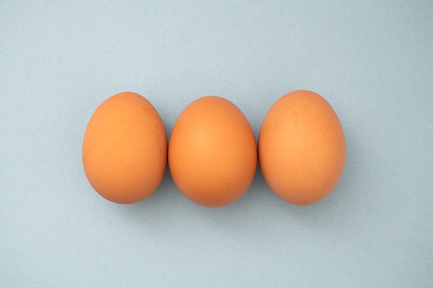 three eggs on a plain background