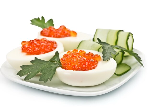 Three eggs stuffed with caviar isolated on white background