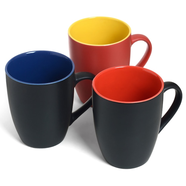 Three empty ceramic mugs on white