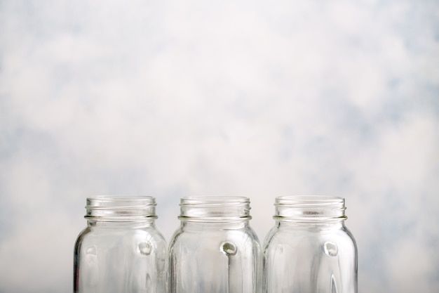 Three empty clean canning jars with drops of water