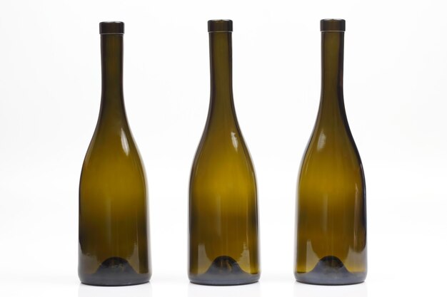 Three empty wine bottles on white background