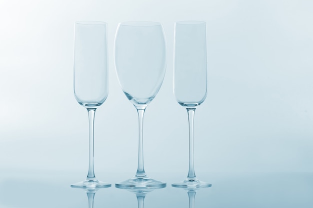 Three empty wine glass on a light surface