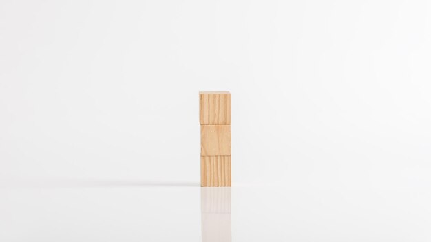 Three empty wooden blocks on a white table