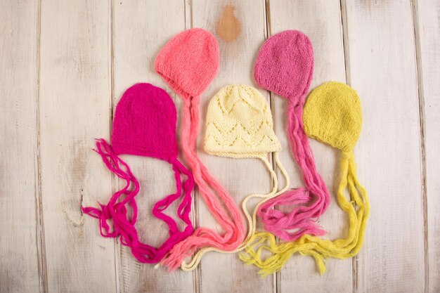 Photo three felted knitting hats on a wooden table