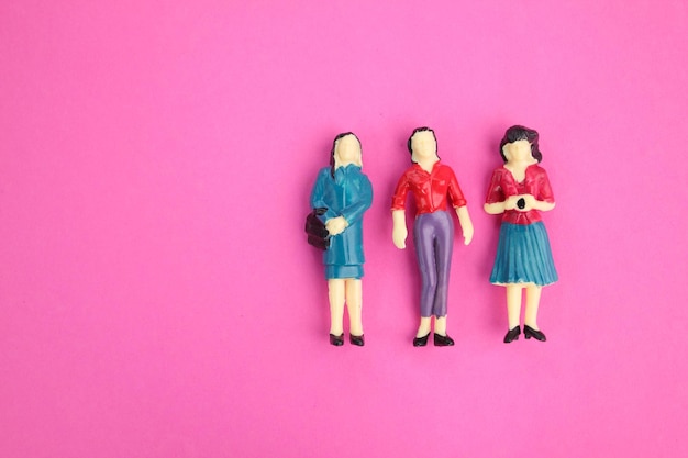 three female miniatures in different clothes business partner concept business woman concept