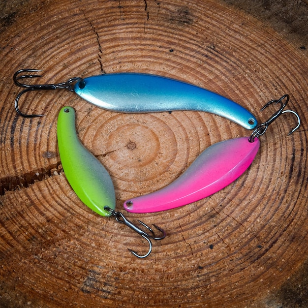 Three fishing lures on wooden desk