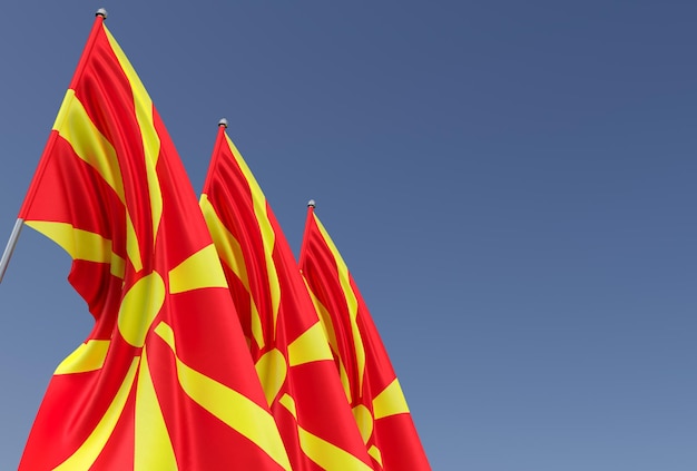 Three flags of Northern Macedonia on a flagpole on a blue background Place for text The flag is unfurling in wind Europe Skopje 3D illustration