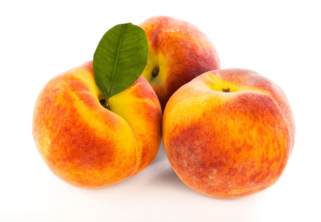 Three fresh peaches isolated