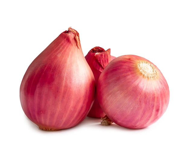 Three fresh red onion bulbs in stack are isolated on white background with clipping path