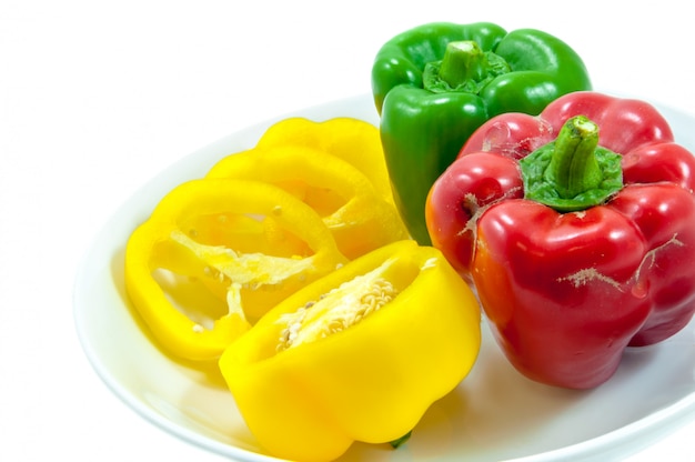 three fresh sweet pepper on ceramic bowl 