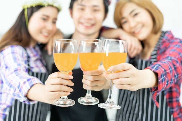 Three friends Enjoying Party glass, drinking orange juice cocktail together