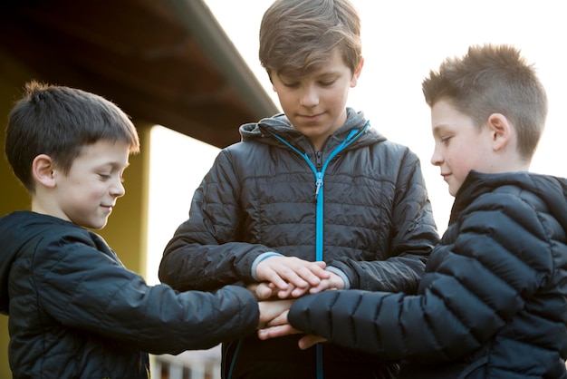 Three friends joining hands