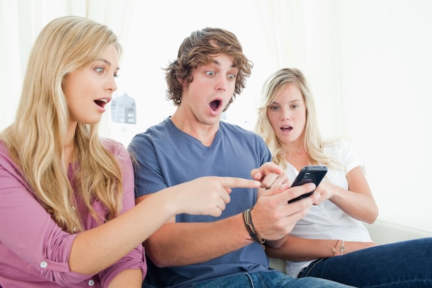 Three friends shocked at the message on the phone