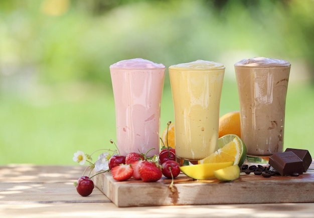 Three fruit or choclate smoothies or milkshakes