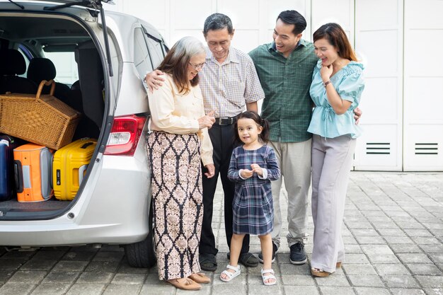 Three generation family with car in the garage