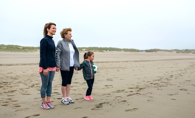 Three generations female watching the sea in autumn