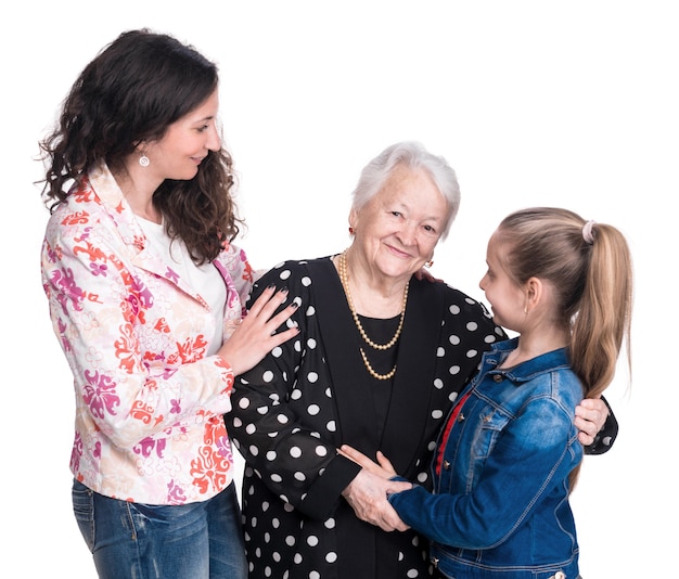 Three generations of women on a white wall