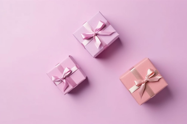 Three gift boxes with a pink ribbon on a pink background.