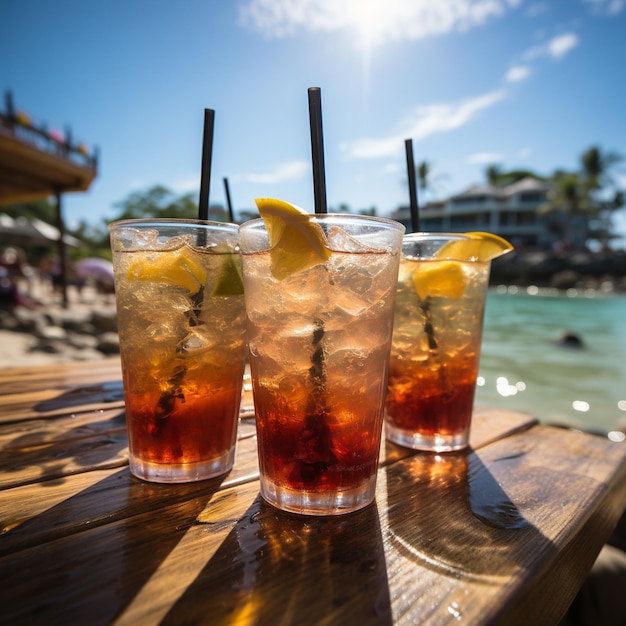 Three glasses of iced tea with straws and a slice of lime.