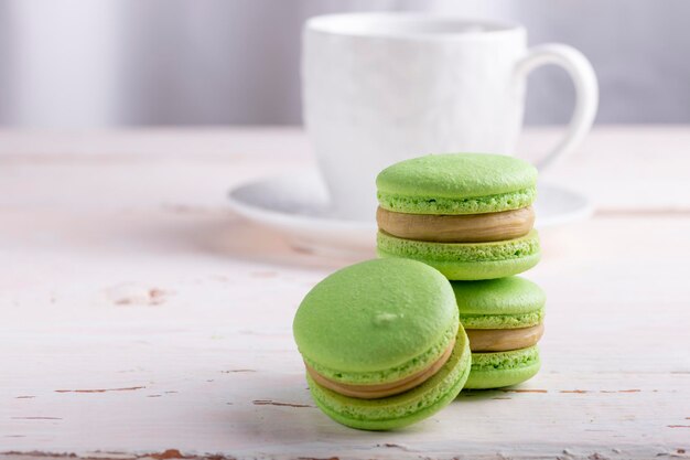 Three green macaroons on a light background