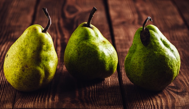 Three Green Pear on Wooden Table