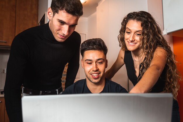 Three guys meeting in front of a laptop