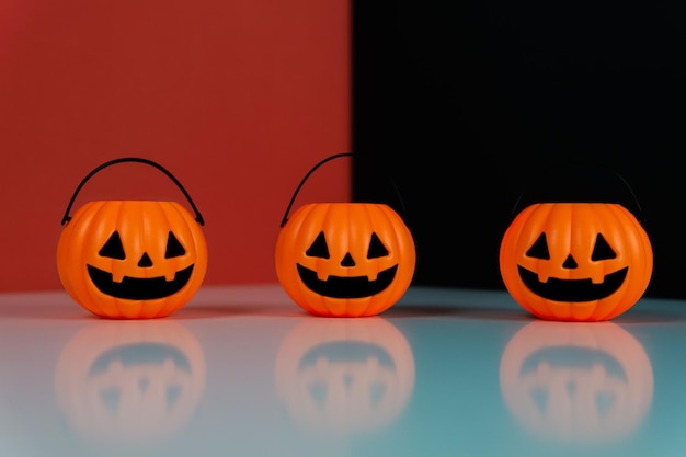 Three halloween pumpkin on a red and black background