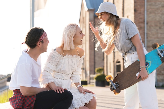 Three happy teenage friends walking in a city