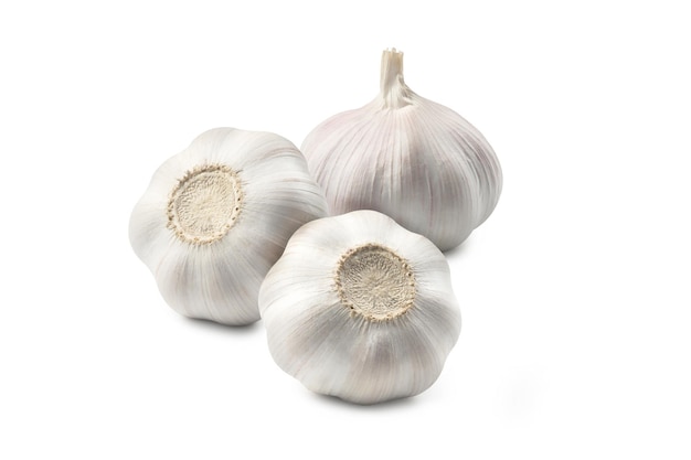 Three heads of garlic laying on white background