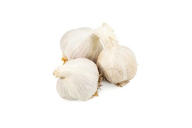 three heads of ripened garlic lying nearby isolated on a white background