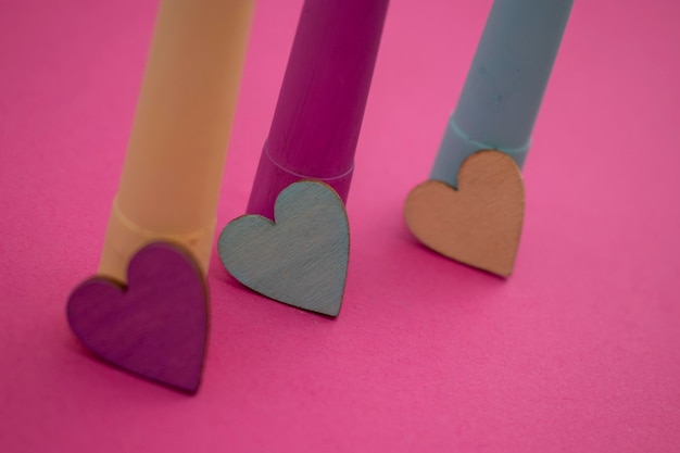 Three hearts on a pink background, one of which is labeled'love '