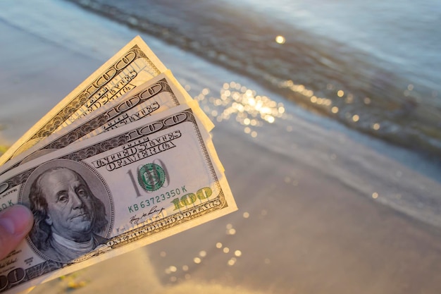 Three hundred dollar bills on background of sea surface  dollar cash