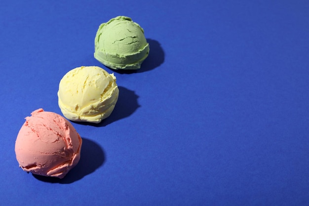 Three ice cream scoops on blue background