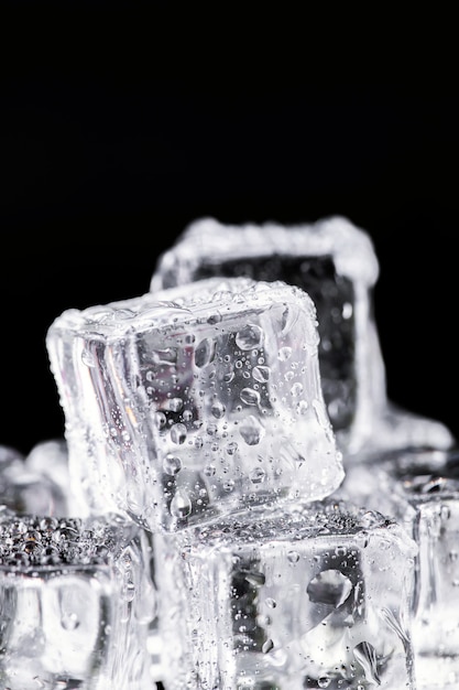 Three ice cubes on black background.