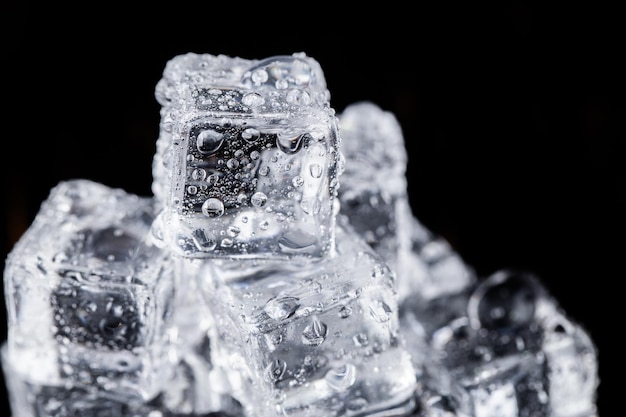 Three ice cubes on black background