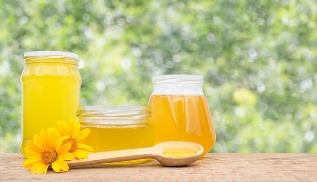 three jars with honey on a defocused background with copy space