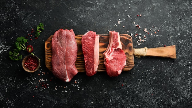 Three juicy raw veal steaks Banner for the supermarket Top view Organic food