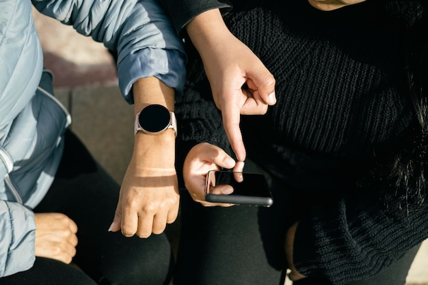 three latin people using their mobile devices and interacting with each other