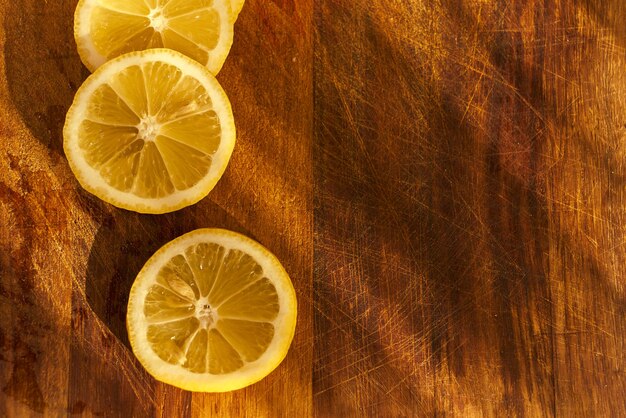 Three lemons on a wooden cutting board