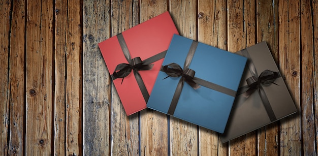 Three luxury gift box on textured wooden table