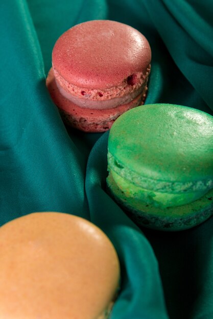 Three macaroons on green . French dessert.