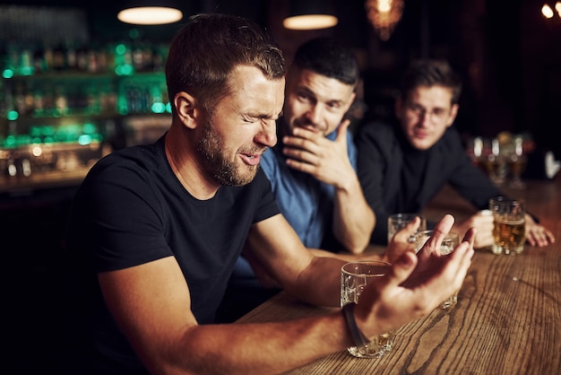 Three male friends in the bar