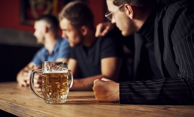 Three male friends in the bar