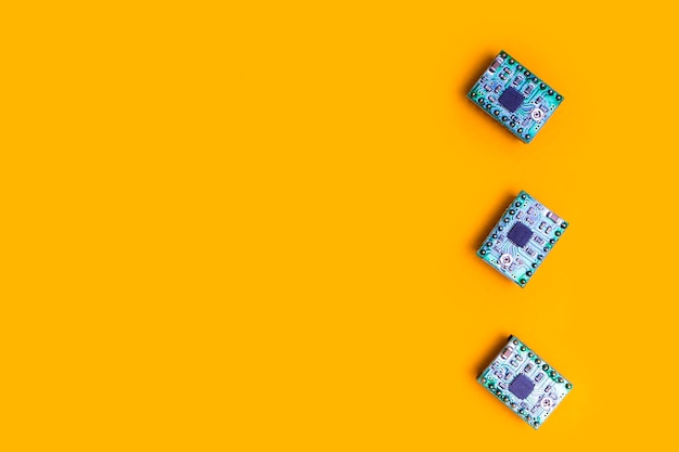 Photo three microcircuit over orange background minimal engineering concept