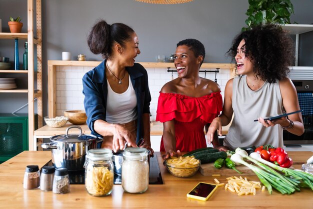 Three mixed race hispanic and black women bonding at home