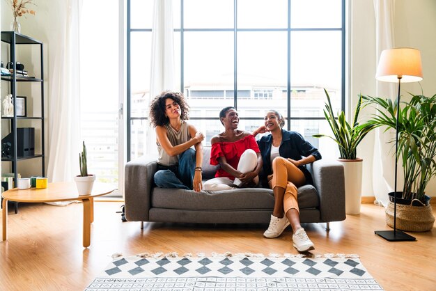 Three mixed race hispanic and black women bonding at home