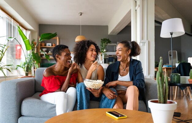 Three mixed race hispanic and black women bonding at home