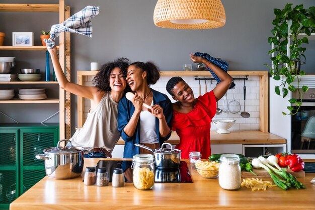 Three mixed race hispanic and black women bonding at home